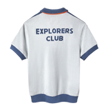 Back view of a short-sleeved terry cloth shirt in white with blue trim. The words “EXPLORERS CLUB” are appliquéd in bold blue letters across the upper back.
