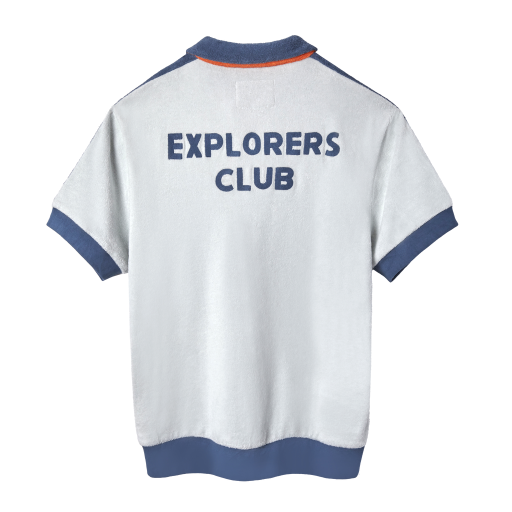 Back view of a short-sleeved terry cloth shirt in white with blue trim. The words “EXPLORERS CLUB” are appliquéd in bold blue letters across the upper back.