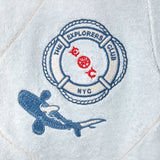Detail shot of the chest patch featuring a Life Raft, with “The Explorers Club NYC,” the letters “E” and “C,” and a small shark illustration.