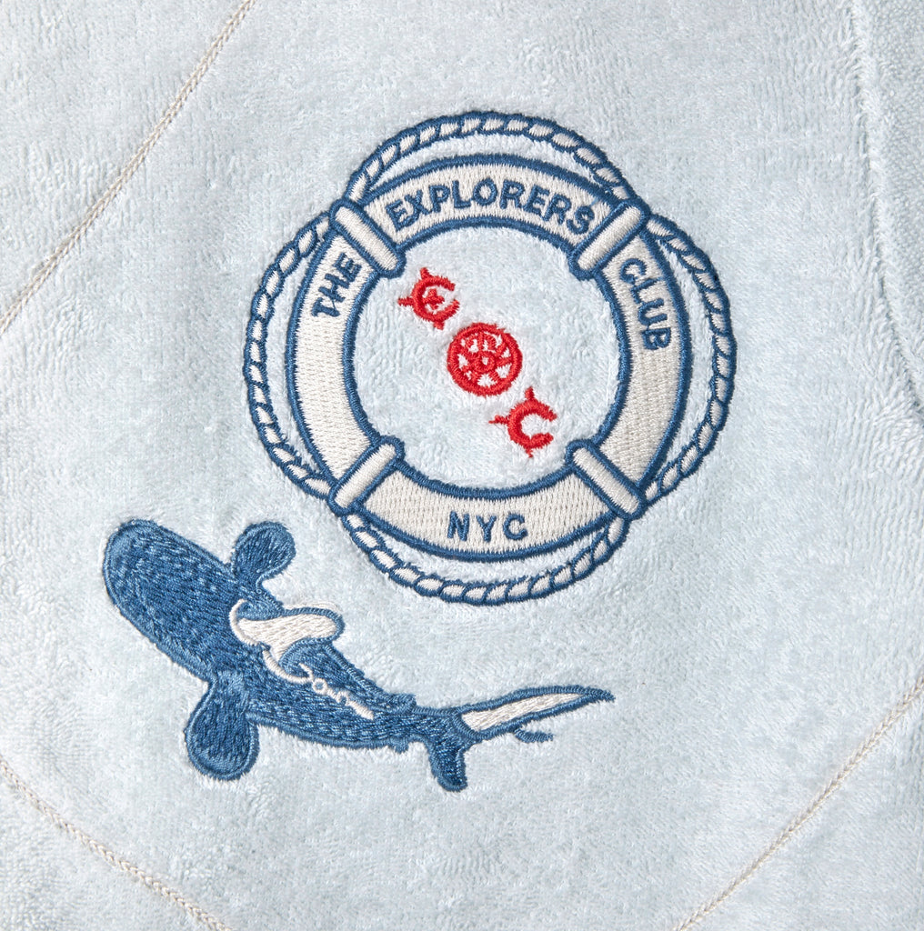 Detail shot of the chest patch featuring a Life Raft, with “The Explorers Club NYC,” the letters “E” and “C,” and a small shark illustration.