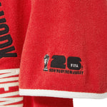 Close-up of FIFA 26 logo on wearer's sleeve.