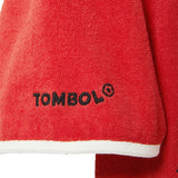 Close-up of red cabana with 'Tombolo' logo on one of the sleeves. 