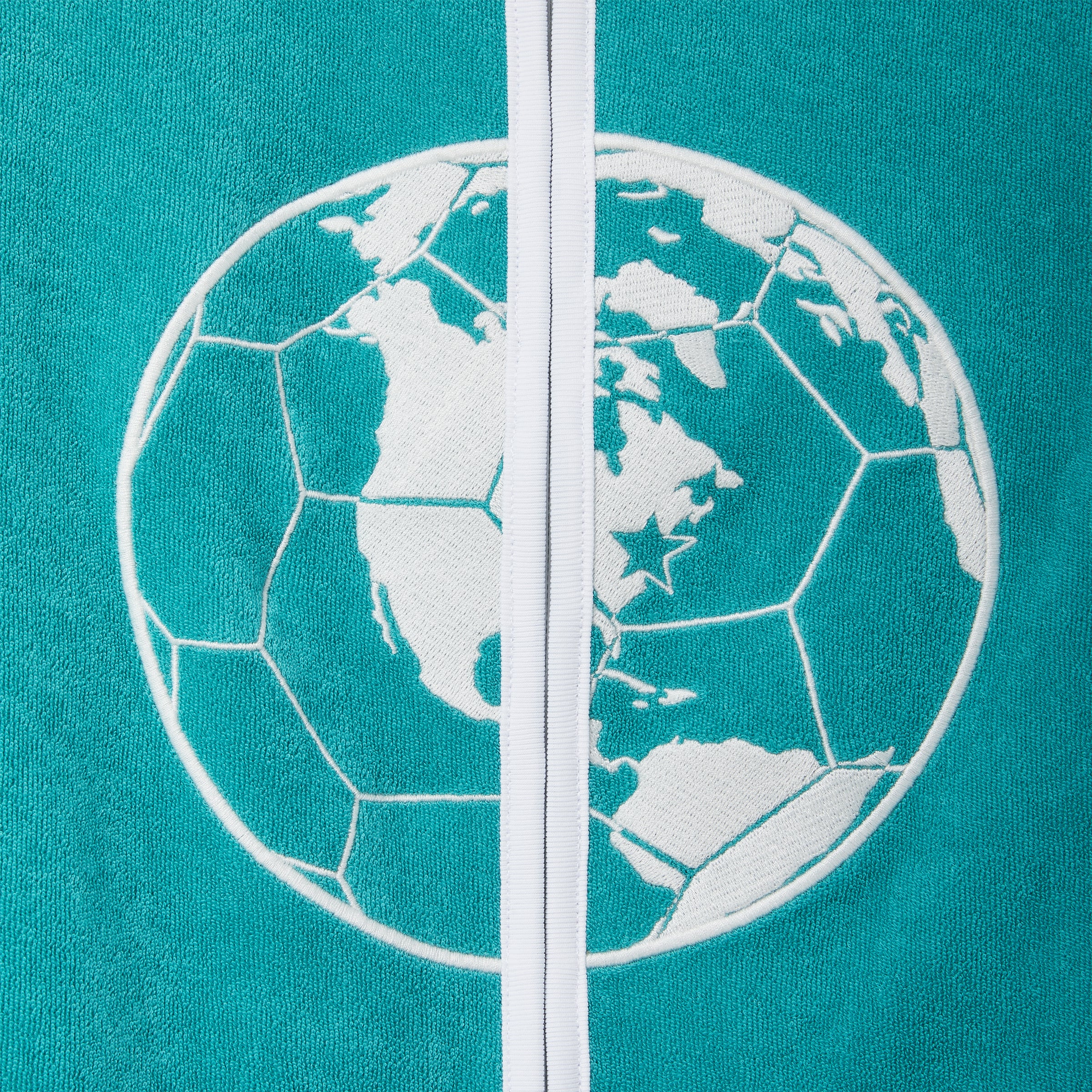 Close-up of teal terry cloth hand towel top with white embroidered globe graphic and front zipper.