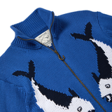 Close-up of a blue zip-up knit sweater featuring a fish design, with a ribbed collar and a brass zipper.