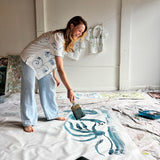 Image of Mary Ball in her studio about to paint. 