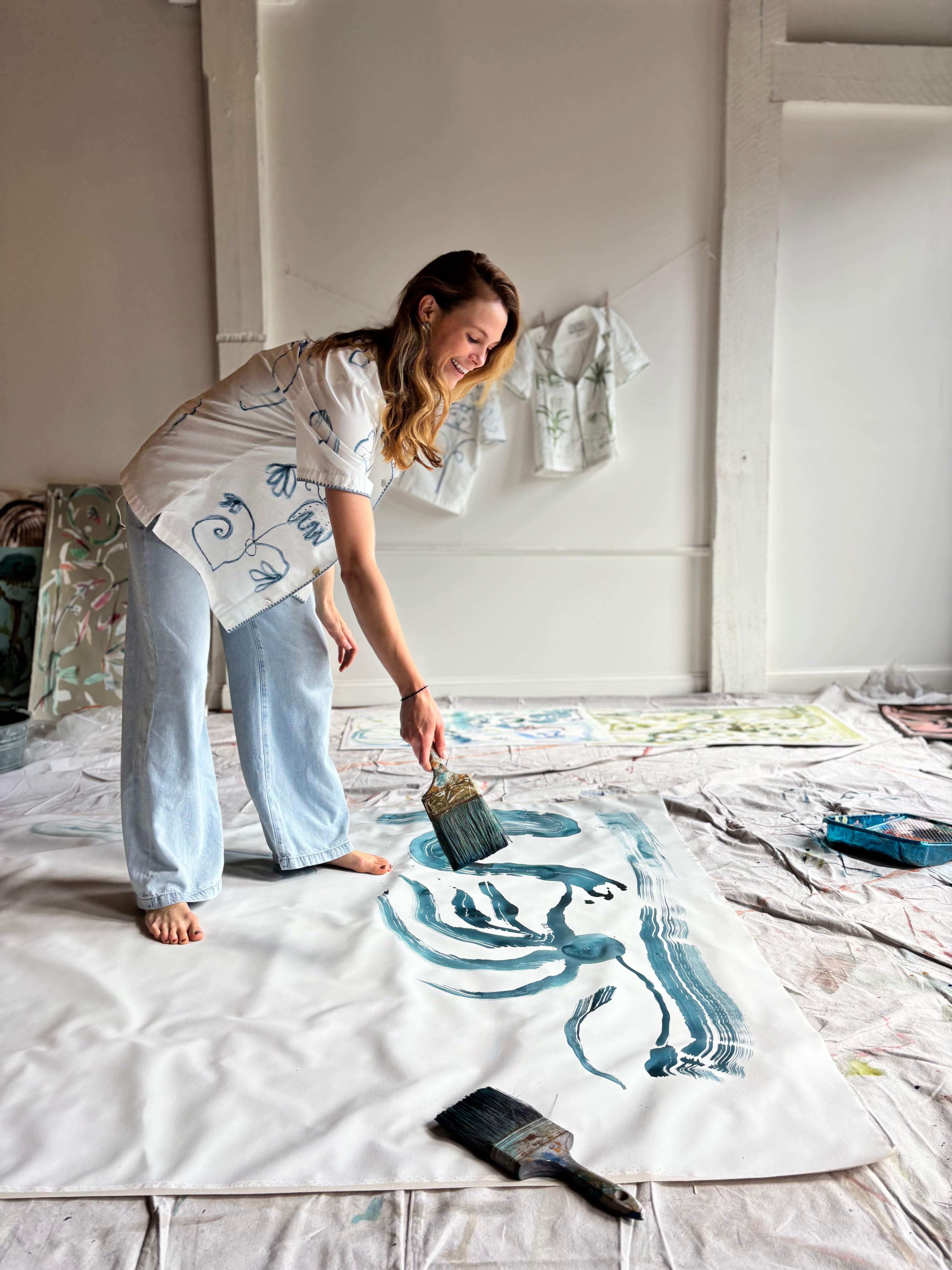 Image of Mary Ball in her studio about to paint. 