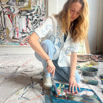 Image of Mary Ball in her studio about to paint. 