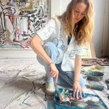 Image of Mary Ball in her studio about to paint. 