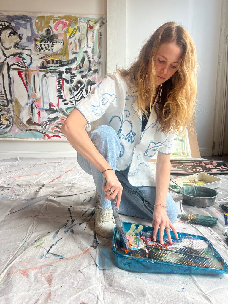 Image of Mary Ball in her studio about to paint. 