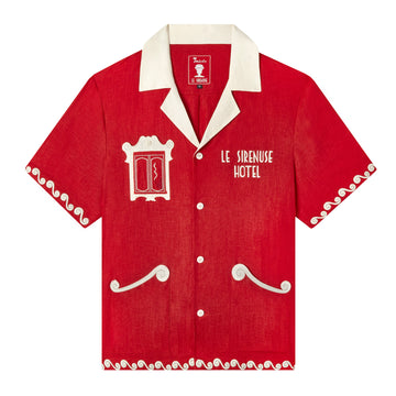 Casual, cabana style red button-up Tombolo x Le Sirenuse Hotel linen shirt with white collar, and white swirl trim on sleeves and bottom of shirt, also has White swirl pockets on bottom right and bottom left, and window facade with smoker on right breast pocket, also with a Le Sirenuse Hotel logo on left breast pocket
