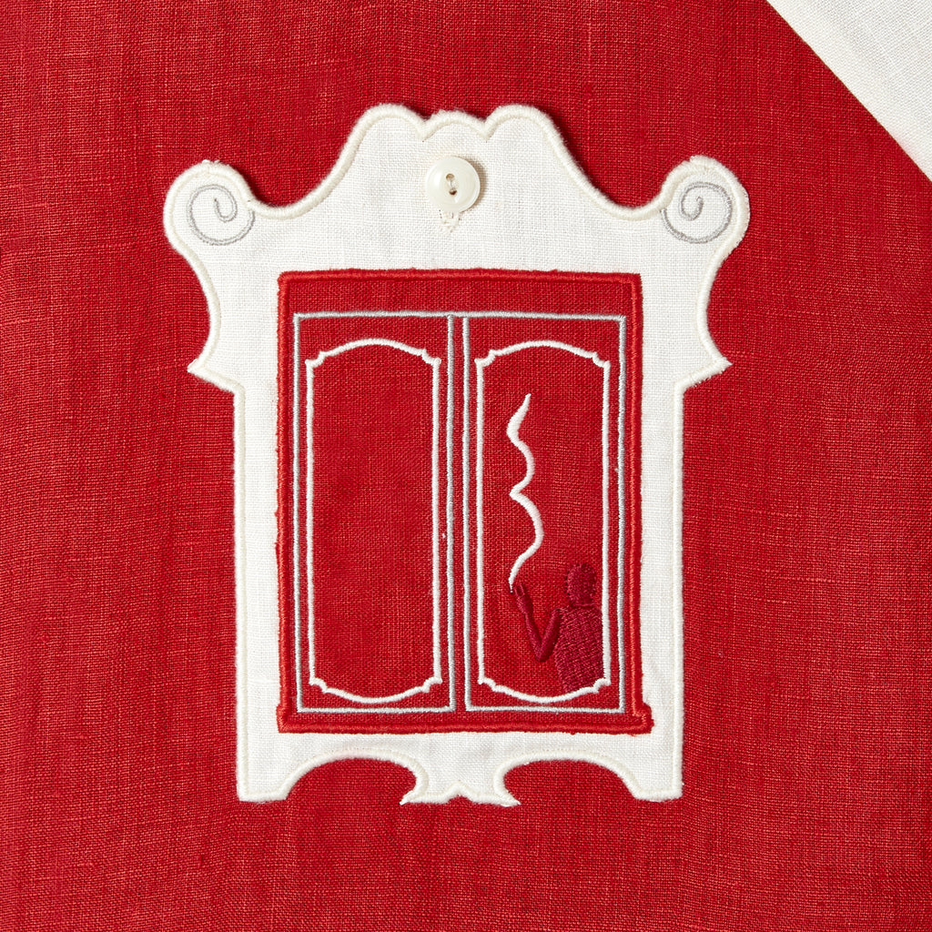 close up of the window style pocket featuring a subtle embroidered man with a cigarette