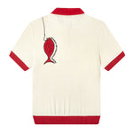 Shot of Da Adolfo shirt from the back, showing an embroidered red fish with a hook connected to the top left of the shirt