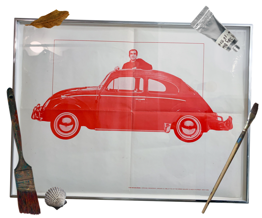 Framed red car poster surrounded by paintbrushes