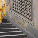 Man walking downstairs, wearing the full Saffron Corduroy Easy Going Suit.