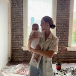 Video of Artist Mary Ball kissing her baby on the cheek while wearing the 'Seasons of Change' Shirt in Green. 