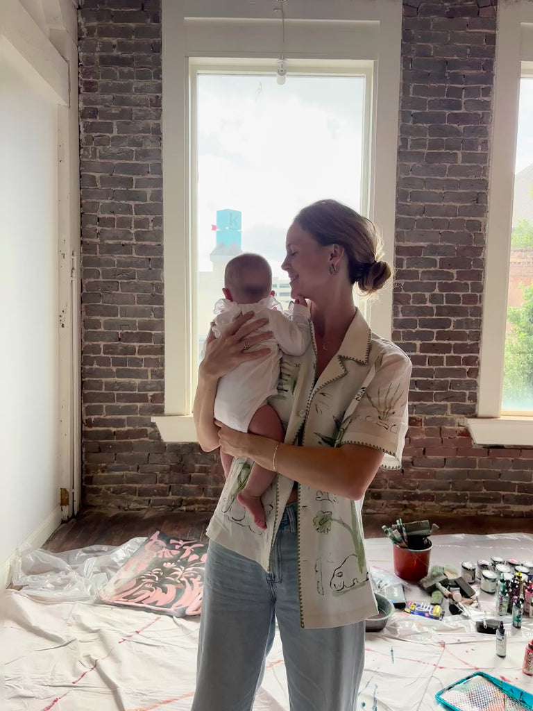 Video of Artist Mary Ball kissing her baby on the cheek while wearing the 'Seasons of Change' Shirt in Green. 