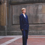 Video of woman wearing full navy corduroy suit. 