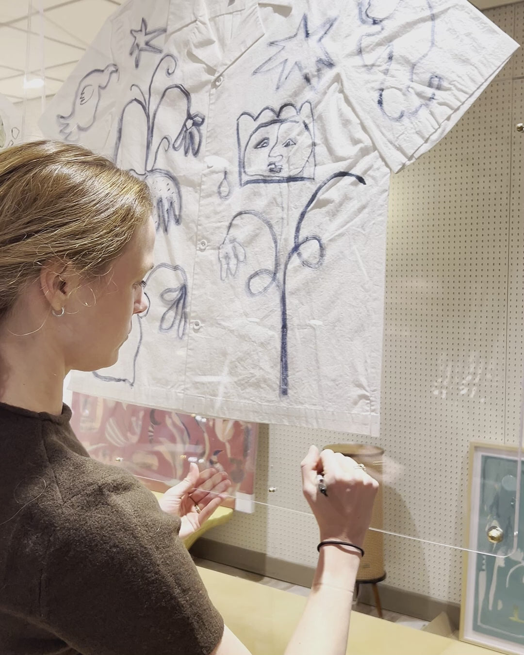 Video of Artist Mary Ball signing her name at the bottom corner of her artwork!