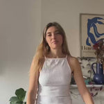 Aemelia talks to the camera, snaps fingers, and then reappears with the conched out shirt on, proceeding to explain how she likes to style the shirt with a denim skirt or baggy white jeans