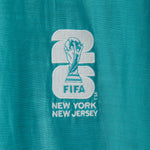 Embroidered FIFA logo on a teal fabric.