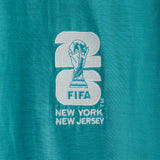 Embroidered FIFA logo on a teal fabric.