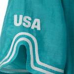 Teal blue shirt with white embroidery and white 'USA' logo patch.