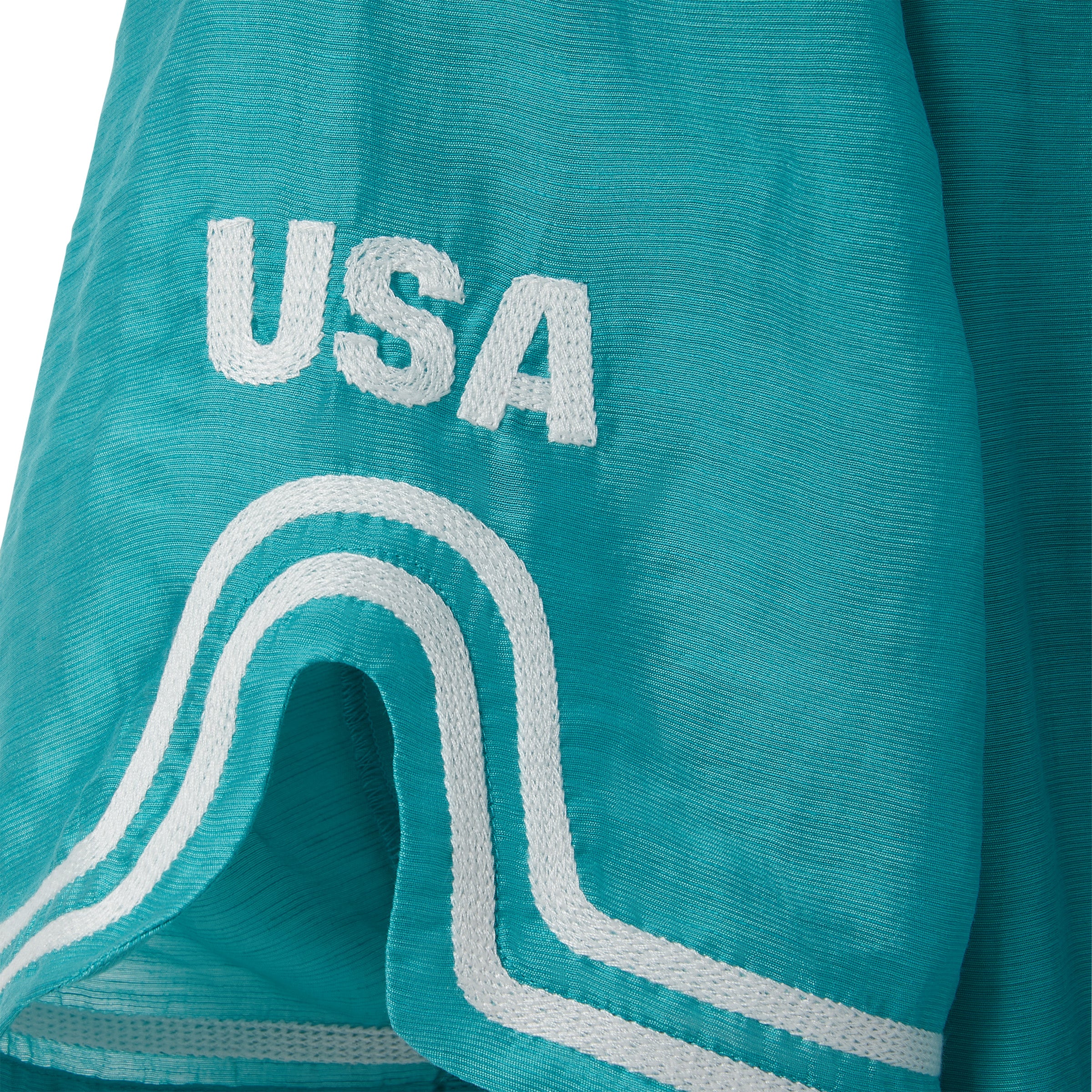 Teal blue shirt with white embroidery and white 'USA' logo patch.