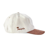 Side view of cap with Tombolo embroidered