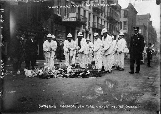 Archive photo of workers gathering garbage, New York, under police guard, black and white