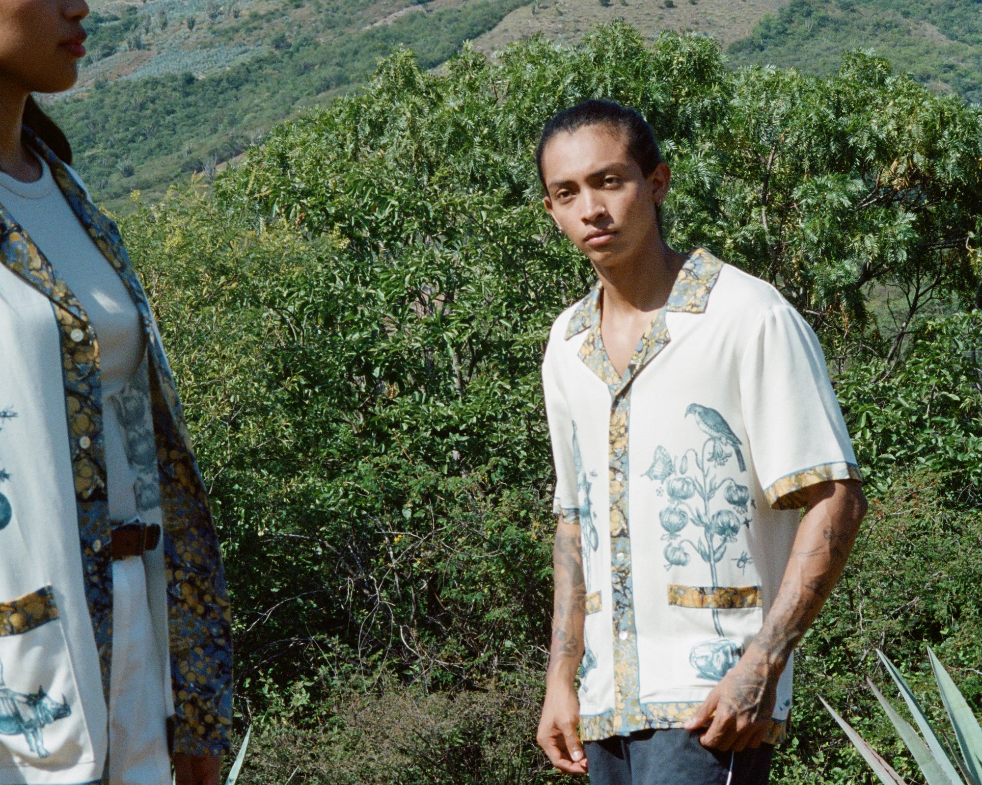 Man stares off camera while wearing Tombolo Alexis Zambrano shirt