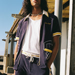 man stares with hand in pocket