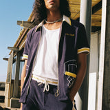 man stares with hand in pocket