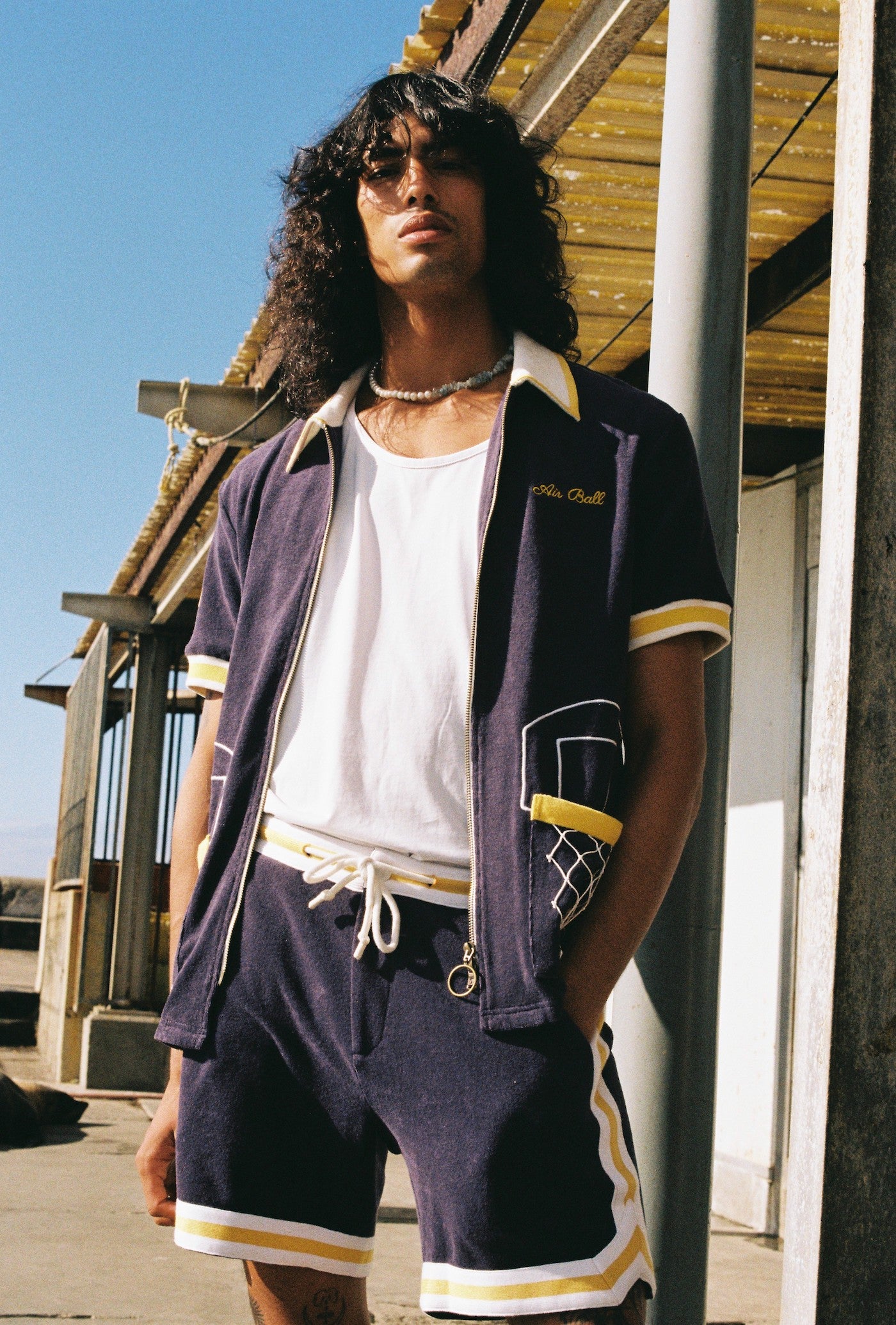 man stares with hand in pocket