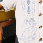 close up of embroidered figures on shirt