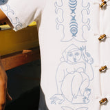 close up of embroidered figures on shirt