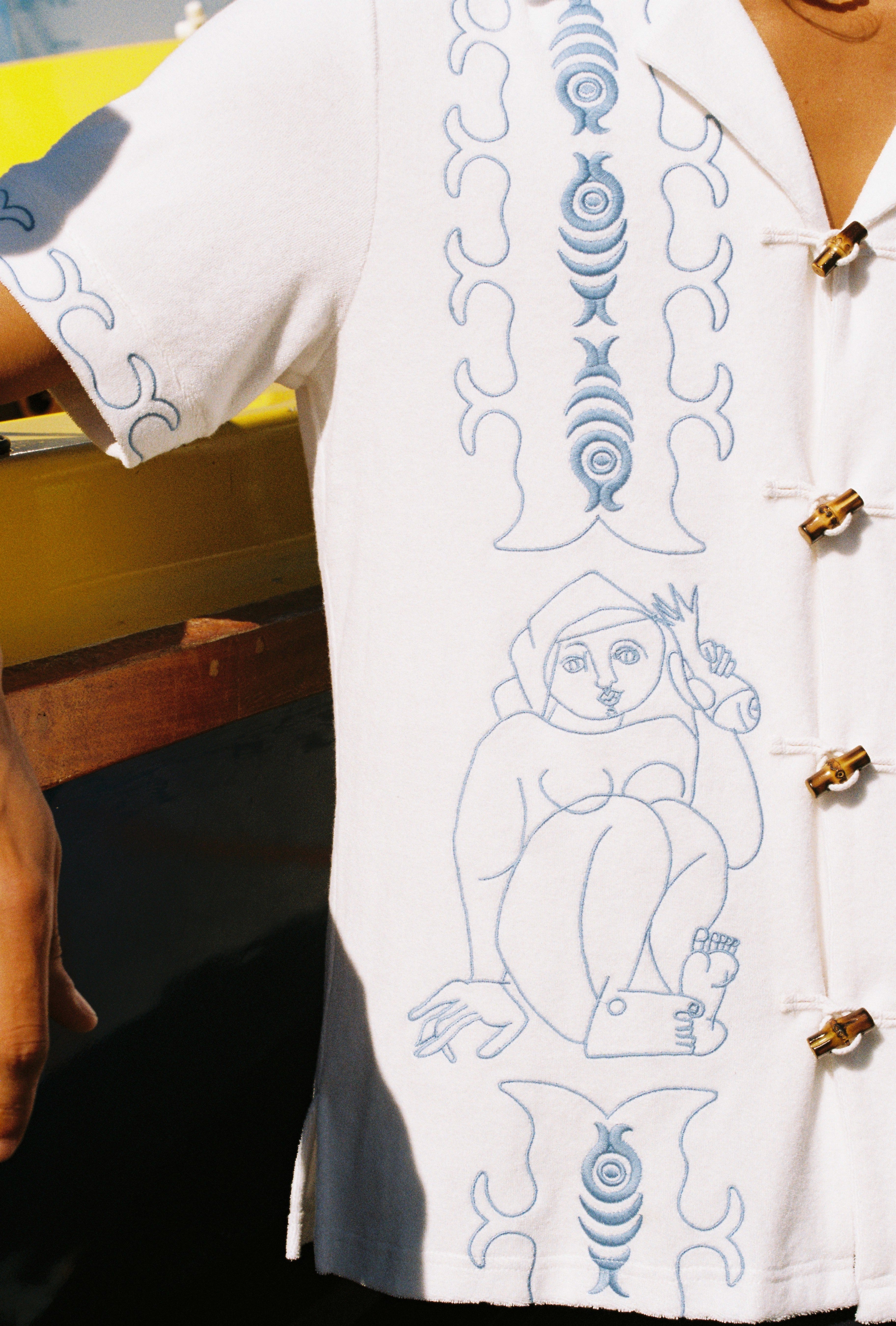close up of embroidered figures on shirt