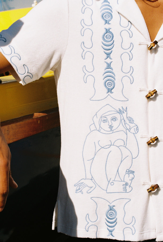 close up of embroidered figures on shirt