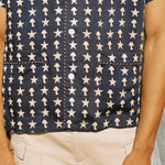Close up of male model wearing shirt with stowaway shorts, arms by his side