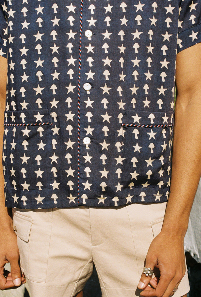 Close up of male model wearing shirt with stowaway shorts, arms by his side