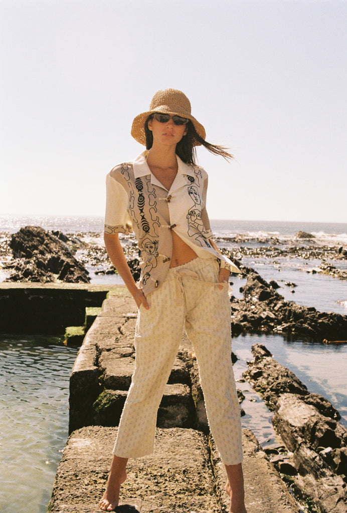 woman poses with hands in pockets