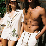 man and woman lean against wall