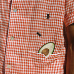 close up of shirt showing ants and avocado motif