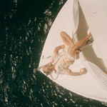 Older male model wearing full set laying out on a boat