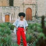 Woman happily sporting oversized Tombolo linen shirt with open, no button look