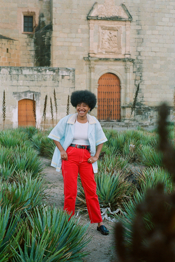 Woman happily sporting oversized Tombolo linen shirt with open, no button look