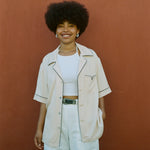 female model smiling wearing her cabrisa standing against a terra cotta wall