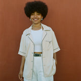 female model smiling wearing her cabrisa standing against a terra cotta wall