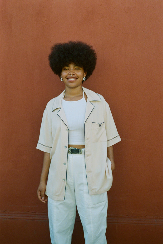 female model smiling wearing her cabrisa standing against a terra cotta wall