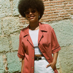 Female model wearing shirt with hand in pocket