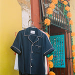 Shirt hanging up on a wall next to a store